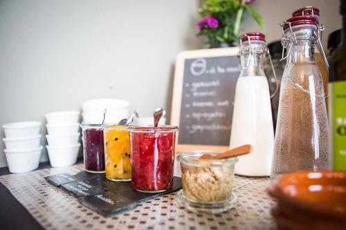 a table with containers of food and bottles of milk at B&B Pastorie van Merkem in Merkem