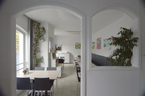 a dining room with a table and chairs at Pension Elisabeth - Rooms & Apartments in Salzburg