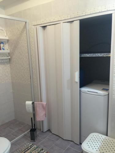a bathroom with a toilet and a shower stall at Da Santina in Scilla