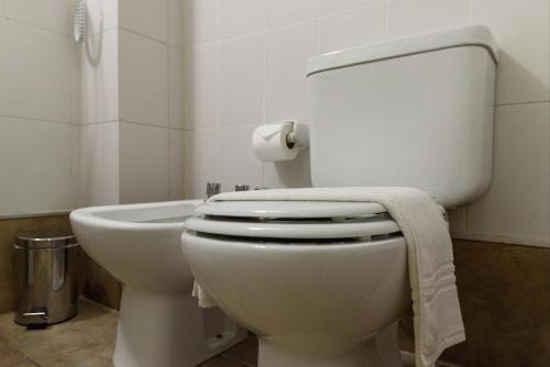 a bathroom with a toilet with a towel on it at Departamentos Lugar in Cordoba