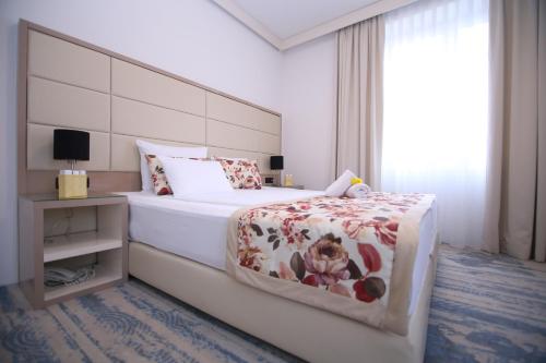 a bedroom with a large bed and a window at Old Town Hotel in Sarajevo