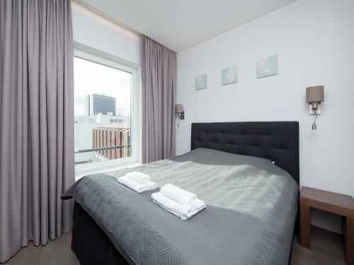 a bedroom with a bed with two towels on it at 8ERA Business Executive Rotermanni Apartments in Tallinn