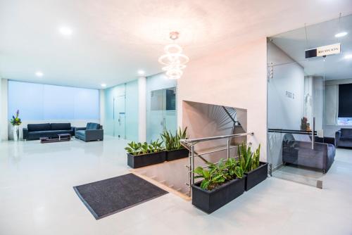 an empty lobby with plants in a building at Ribai Hotels -Riohacha in Ríohacha