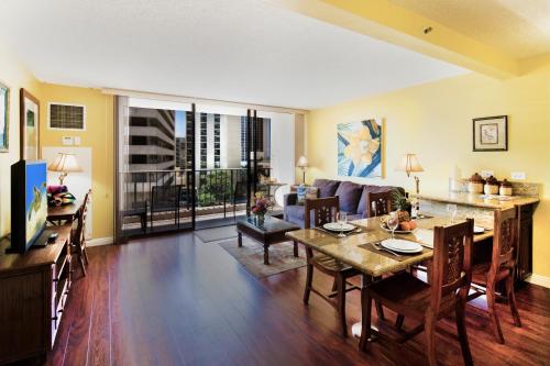 a living room with a dining table and a couch at Waikiki Sunset Mountain View Near Beach with Parking in Honolulu