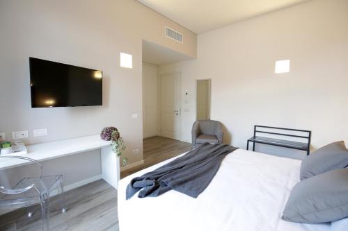 a bedroom with a bed and a tv on the wall at Villa Liberty in Como