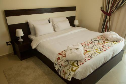 a bedroom with a large bed with a purse on it at Elite Residence Aqua Park in Ain Sokhna