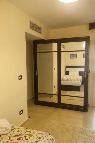 a mirror in a room with two beds at Elite Residence Aqua Park in Ain Sokhna