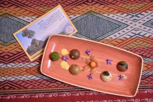 a plate of food with olives on a rug at Casa del Sol Machupicchu in Machu Picchu