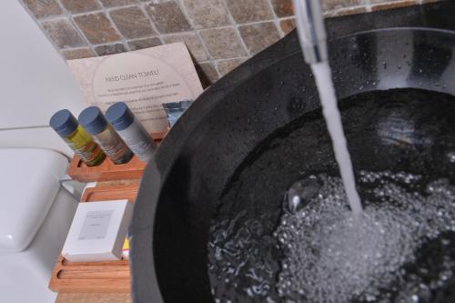 a pan with water pouring out of it at Casa del Sol Machupicchu in Machu Picchu