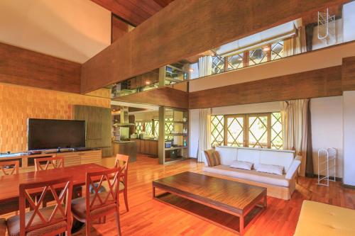a living room with a couch and a table at Phuripimarn Penthouse in Pak Chong