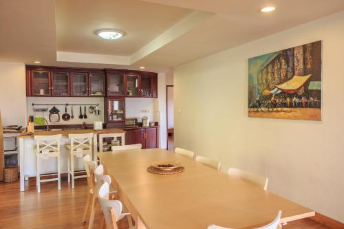 a dining room and kitchen with a table and chairs at Phuripimarn Penthouse in Pak Chong