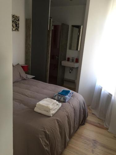 a bedroom with a bed with two towels on it at Le Bellevue in Wimereux