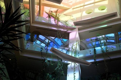 a building with a glass ceiling with plants and lights at Best Western Premier Ark Hotel in Tirana