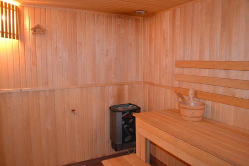 a wooden sauna with a trash can and a trashcan sidx at Vila Evelina in Druskininkai