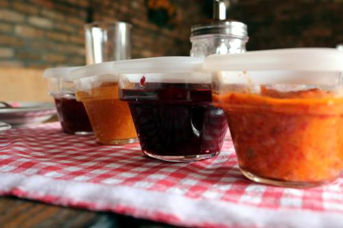 tres frascos de comida sentados en una mesa en Apartmani Špoljar, en Županja