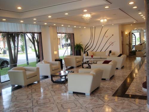 
a living room filled with couches and tables at Hotel Montecarlo in Mar del Plata
