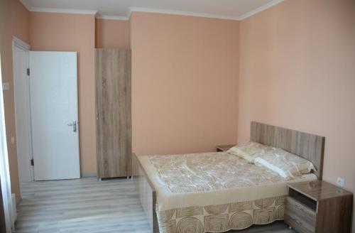a bedroom with a bed and a door to a hallway at G.M.M Apartaments in Batumi