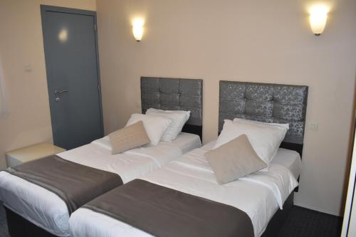 Postel nebo postele na pokoji v ubytování Hôtel Méribel