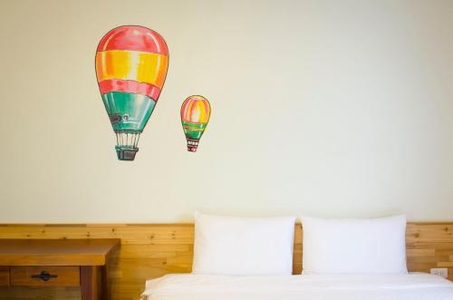 a bedroom with two hot air balloons on the wall at XinFu Traveler Inn in Taiping