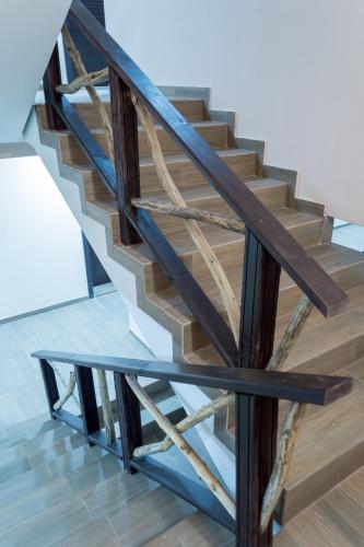 a wooden staircase with a glass table at Complex Friends in Pleven