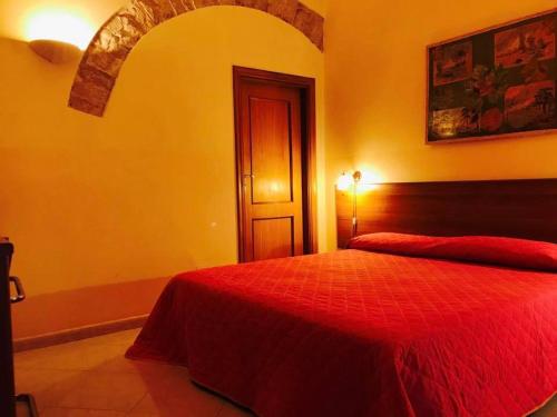 a bedroom with a red bed in a room at Corato room economy in Corato