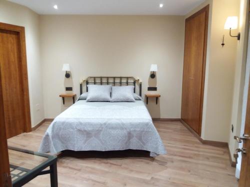 a bedroom with a bed and two side tables at El Cobijo de los Arribes in Fermoselle