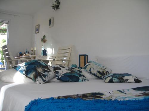 a bed with blue and white pillows on it at Apartment Tanja in Supetar