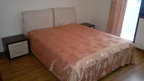 a bedroom with a bed and two night stands at Borovets Holiday Apartments - Different Locations in Borovets in Borovets