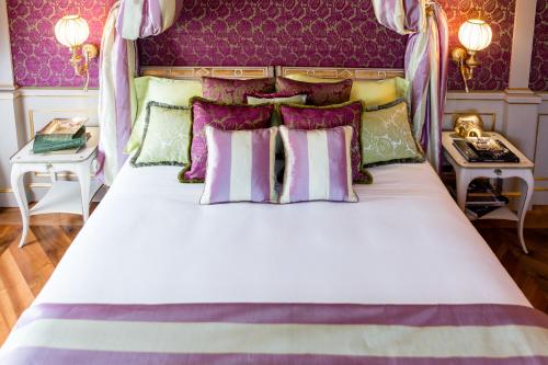 a bedroom with a white bed with purple walls at Villa Cora in Florence