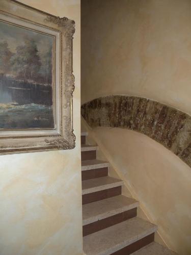 a stairway with a painting and a stair case at La Giada in Tivoli