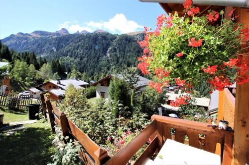a view from the balcony of a house with flowers at Chalet Deleglise 1 in Valfréjus