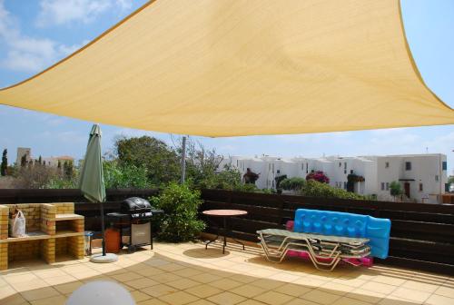 a large yellow umbrella on top of a roof at Villa Vista in Paphos City