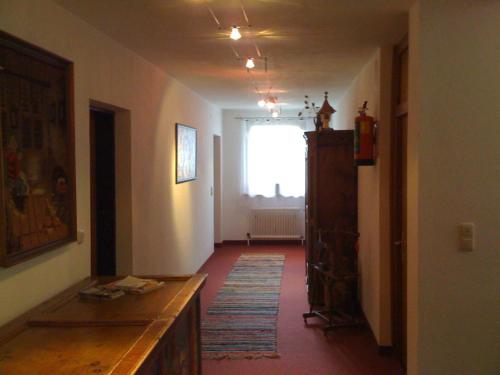 a hallway with a room with a window and a table at Pension und Apartment Edelweiß in Heiligenblut