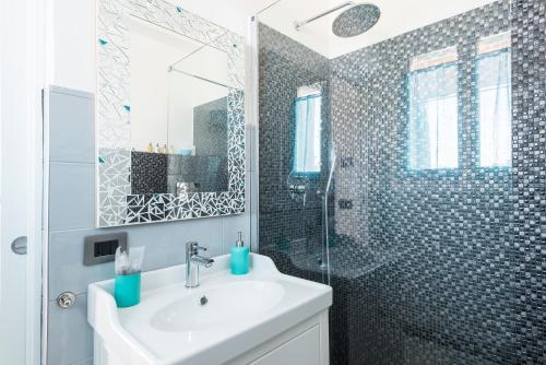 a bathroom with a sink and a shower at Attico Del Duomo in Modena