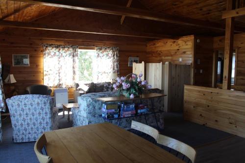 a living room with a table and a couch at Chalets Grand Pre Cottages in North Rustico