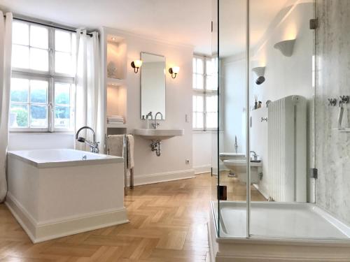 a bathroom with a tub and a sink and a shower at Townhouse Solingen in Solingen