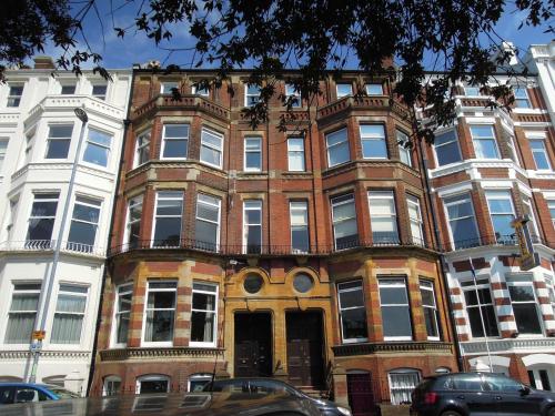 a large brick building on a city street at Special seafront apartment in Portsmouth