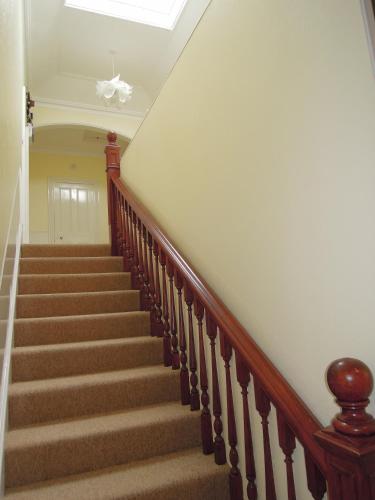 a staircase in a home with a white ceiling at Special seafront apartment in Portsmouth