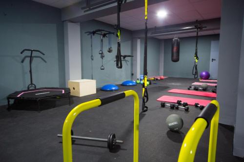 a gym with a bunch of equipment in a room at Athina Airport Hotel in Thérmi