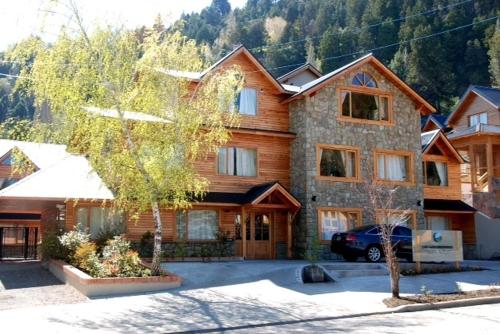 a large house with a car parked in front of it at Departamento de Alquiler Turistico in San Martín de los Andes