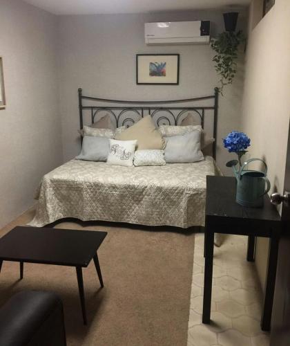 a bedroom with a bed with pillows and a table at Departamentos con Alberca in Mazatlán