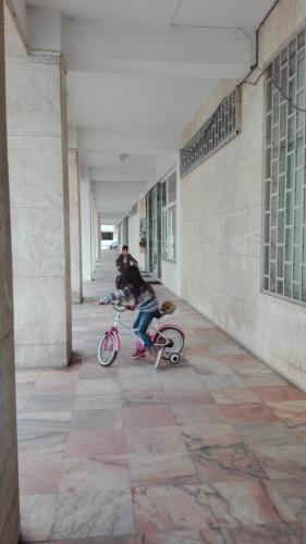 a person riding a pink bike in a building at Lisbon Coast Flat in Quinta de Santo António