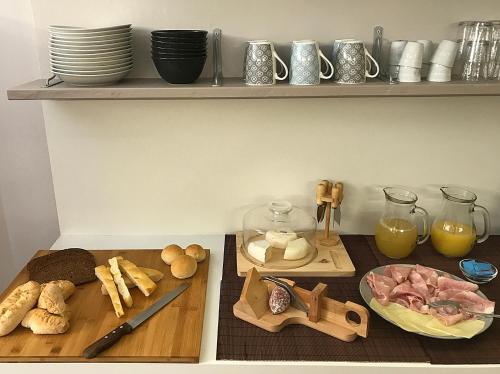 a kitchen counter with a table with food on it at Casa Soave B&B in Alba