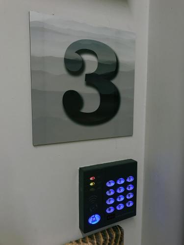 a remote control with the number three on a wall at Casa Soave B&B in Alba