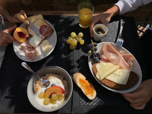 a table with three plates of food on it at Casa Soave B&B in Alba