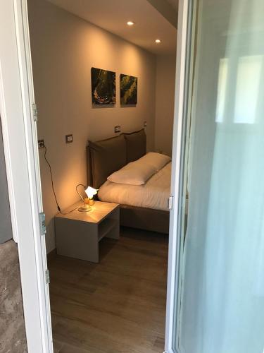 a small bedroom with a bed and a table at Casa Soave B&B in Alba