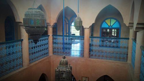 a room with a mosque with two domes and windows at Villa du Souss in Agadir