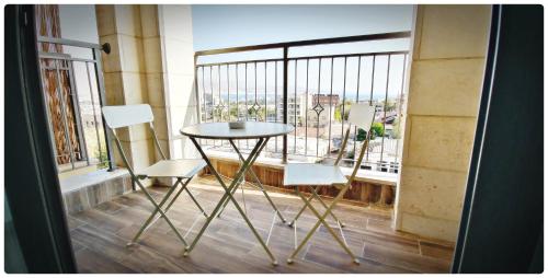 a table and two chairs on a balcony with a view at Red Mountains apartments in Eilat