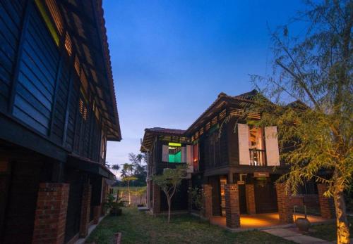a building that is next to another building at The Daun Resort Langkawi in Pantai Cenang