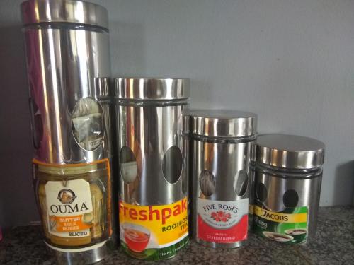 a group of four metal containers sitting on a counter at East Cottage in Boksburg